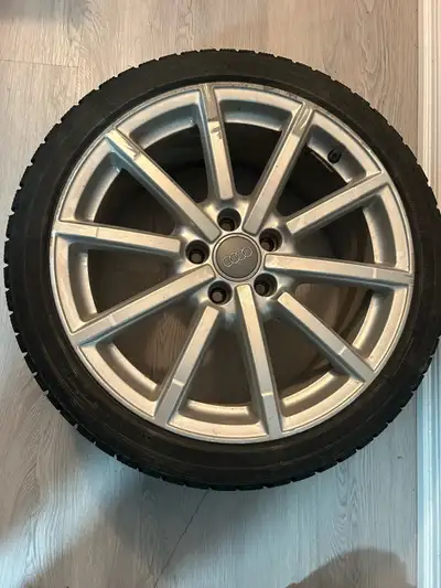 These are used Audi winter tires mounted on 18-inch wheels, perfect for navigating snowy conditions....