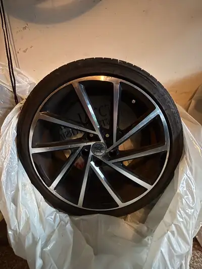 set of used aftermarket Mk7 Golf R style rims with tires, sized 225/40ZR18. The tires are included a...