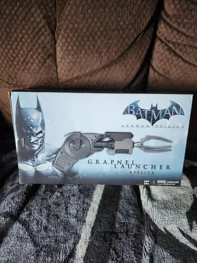 I have a brand new in box Batman Arkham Origins Grapnel Launcher Replica made by NECA for sale for $...