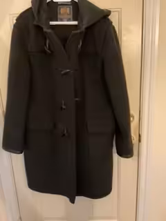 Made in England by Gloverall-the origional duffle coat. Has a hood, wooden toggles. Made of 80% wool...