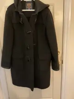 Made in England by Gloverall-the origional duffle coat. Has a hood, wooden toggles. Made of 80% wool...