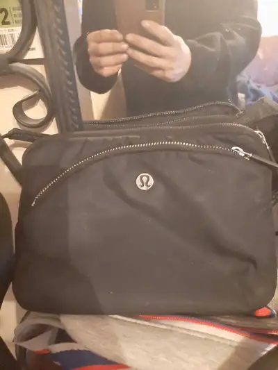 This black Lululemon crossbody bag is perfect for carrying your essentials while on the go! It's in...