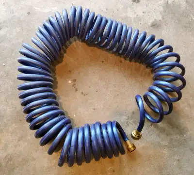 Coiled garden hose / Boyau d'arrosage enroulé, View more