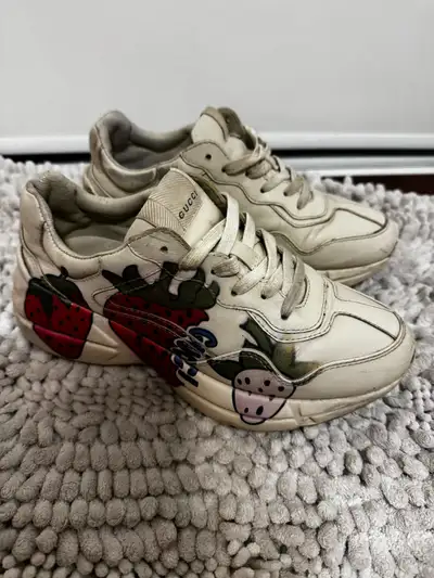 Selling a pair of Gucci sneakers with a fun strawberry print! They're made of leather and have a uni...