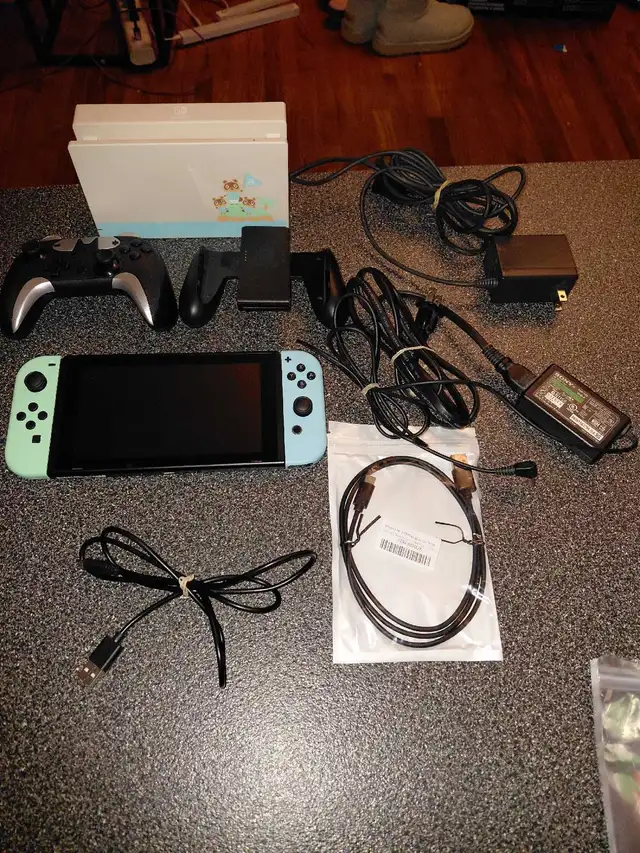 NINTENDO SWITCH WITH ACCESSORIES AND GAMES