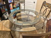 Glass table with four chairs and baker’s wine rack