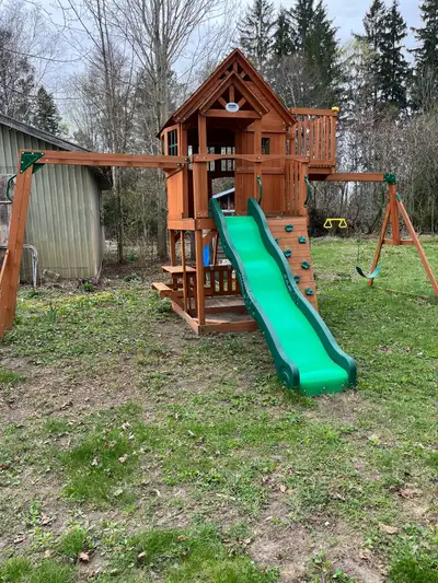 Complete with slide, swings, picnic table, monkey bars, two upper levels, slide , climbing wall and...