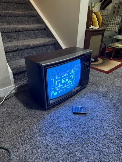 This is a vintage wood grain sears TV set with the remote control. The TV works but only seems to pr...