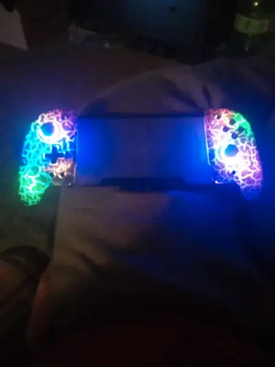 Enhance your gaming experience with this used Nintendo Switch with customized, colour changing joyco...
