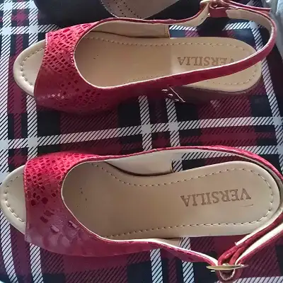 A cute pair of Versilia wedge sandals in a size 34. Made in Colombia. They feature a peep toe and an...