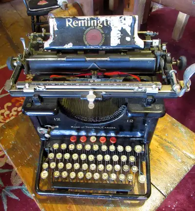 Antique Remington typewriter No. 12 in good working condition measuring 16 inches deep and 14 inches...