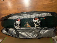 Snowboard, binding and travel bag