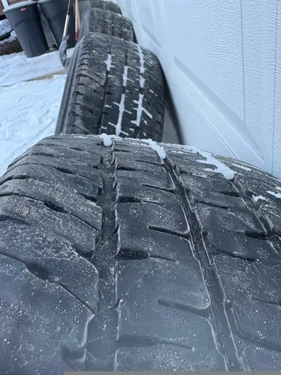 These are a set of four GMC Sierra 2500 tires and rims, size LT265/70R18, in used condition. They ar...