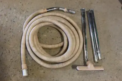 26' long x 1 1/4" diameter vacuum hose with wand and floor brush. Used, end cuff on the hose is crac...