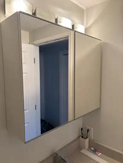2 mirrored medicine cabinets, to be installed together. 25” tall, 8 3/8” deep and combined they are...