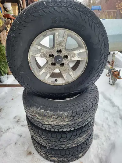 16 inch kuhmo road venture AT truck tires with snow flake. Mount on stock ford ranger rims. Bought n...