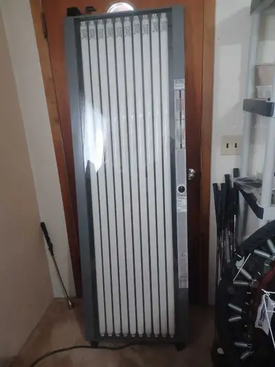 Over the door, 10 bulb tanning lamp. Barely used