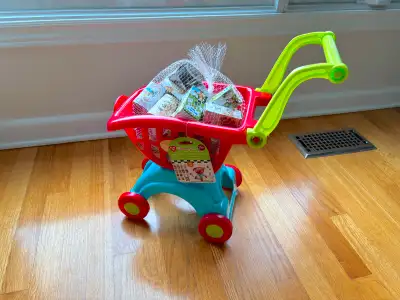 Brand new. Toddler shopping cart toy with play food boxes. Smoke-free, pet-free home.