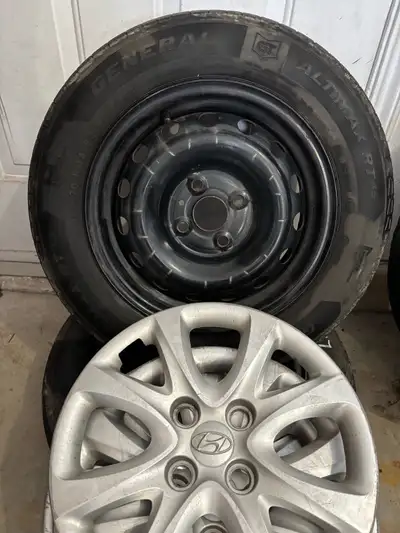 P175/70R14 steel wheels and hub caps from 2013 Hyundai Accent. Tires are worn and unusable.