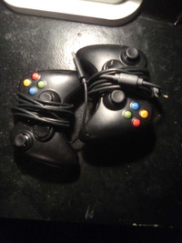 2 black Xbox 360 controllers 