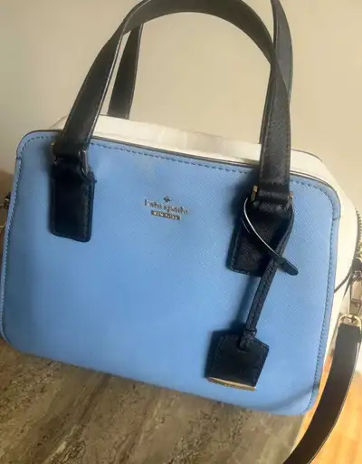 This is a Kate Spade satchel in baby blue, white, and black. It's the perfect size for everyday esse...