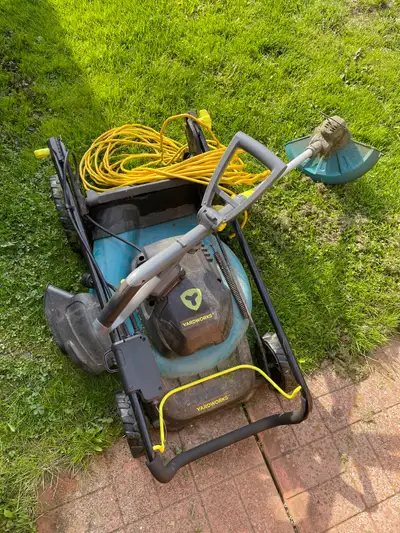 Yardwork Electric lawn mower includes long cord. Plus battery operated weed trimer includes battery...