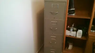 Filing Cabinet Metal four sliding door Ask $40, View more