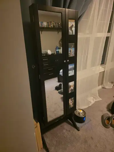 Photo-display door, swing-out necklace bars, earring racks, shelves, hooks, and full-length mirror.