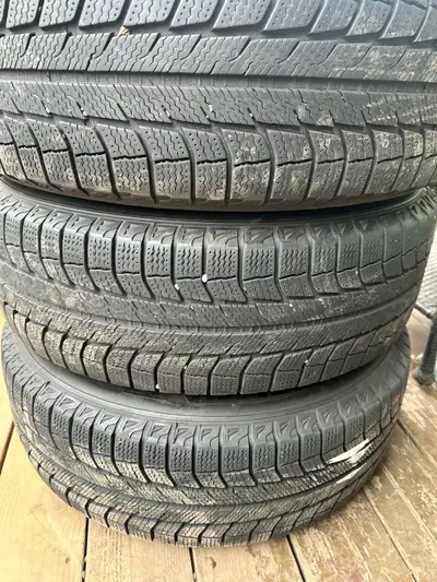 Offering a set of Michelin winter tires, size 225/65R17, mounted on rims and featuring an 8/32 tread...