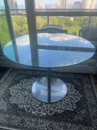 Glass dining table round with silver pedestal 