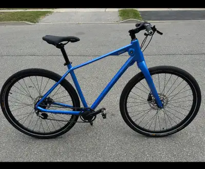 The BMW Cruise Bike in blue is a lightweight, urban-focused bicycle that draws inspiration from the...