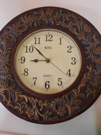 Wooden wall clock with metal decoration