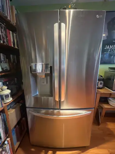 This is an LG refrigerator, featuring a door-in-door design and a bottom freezer. It's in used, but...
