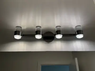 Brighten your bathroom with this elegant 4-light vanity fixture featuring a modern chrome finish and...