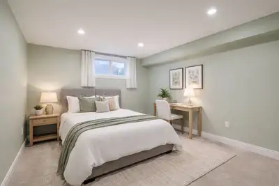 This basement apartment room is a cozy and modern living space, featuring a well-equipped kitchen, a...