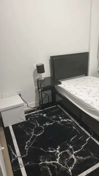 This room is furnished with a bed and a nightstand, perfect for a student or young professional. Ple...