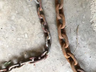 Two used heavy duty tow chains with clevis hooks on each end for sale. One is 13 feet long with Larg...