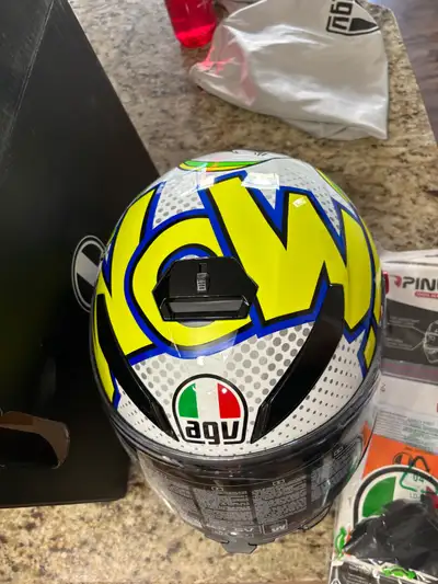 This AGV K3S helmet, size MS, is in like-new condition, featuring a vibrant and eye-catching design....