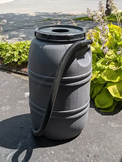 Grey 220 litre, 55 gallon repurposed food grade plastic rain barrel. Used for 1 season in great cond...