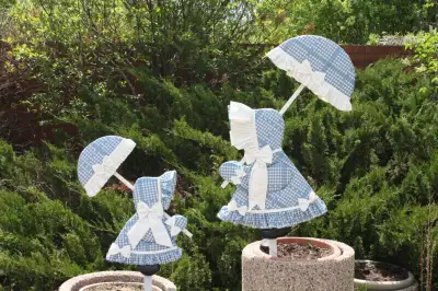Yard decorations, pair of Garden Girls on stakes. Blue and white clothing made of vinyl fabric; fair...