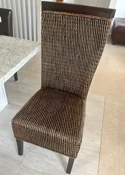 A set of four rattan/wicker wood chairs ($200 each) purchased from Pier 1 Imports. (The regular pric...