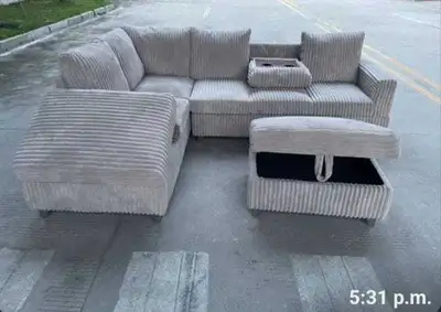 This is a beautiful, light grey corduroy sectional sofa that features a modular design with a storag...