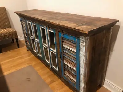 Well cared for stressed side board buffet, made in Mexico. Solid wood with glass doors. 75 inches by...
