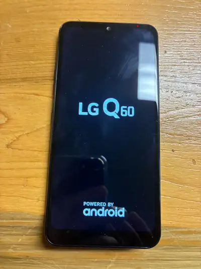 Barely used LG Q60 phone and holder, View more