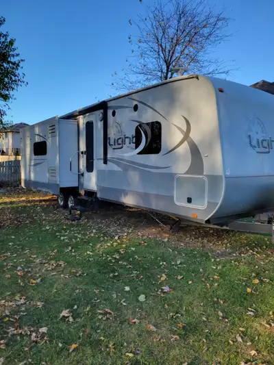 Used 2017 open range light, model #272RLS, 2 slides, private bedroom sleeps 6. Outside kitchen with...