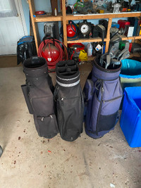Left hand partial set of golf clubs and 2 empty bags