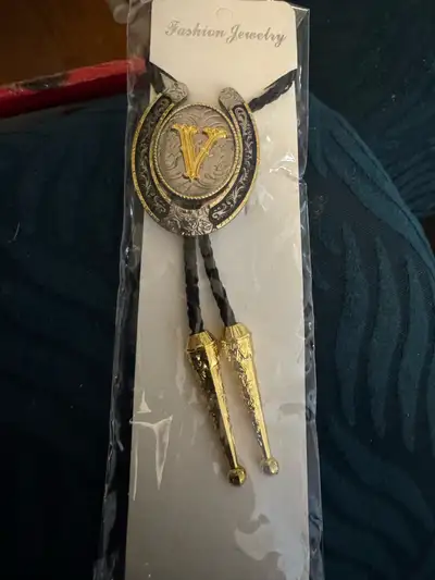 I'm selling a brand new bolo tie, still in its original packaging! It's a stylish piece of fashion j...