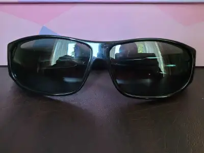Large sized sunglasses designed to fit over other glasses.