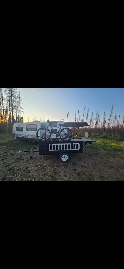 4.5x8 built into a camping rig thats lockable and keeps things dry, top slids out to a table and whe...