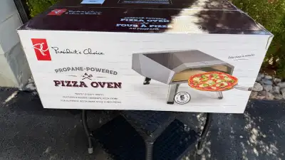 I'm selling a President's Choice propane-powered pizza oven, brand new in its original, unopened box...